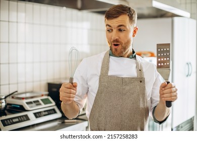 Man Baker Holding Whisk And Spatula