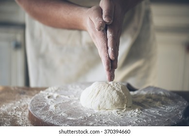 Man Baking Bread In The Kitchen.