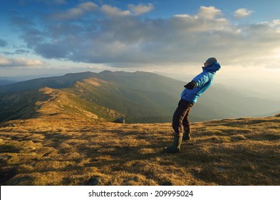 Man Balances. Strong Wind In The Mountains. Autumn Landscape