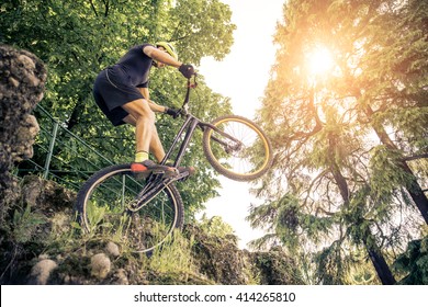 Man balancing on one wheel with his acrobatic bike - Powered by Shutterstock