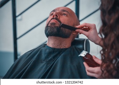 a man in a barber shop for a professional treatment hair and beard - Powered by Shutterstock