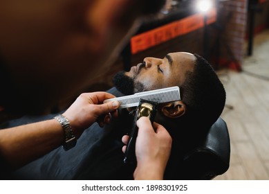   Man In The Barbershop. Cute Black Man Makes A Haircut In The African Salon. Hair Style. Haircut For Adults.