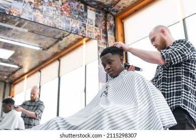 Man At The Barbershop. Handsome Black Man Getting A Haircut In An African Salon. Hairstyle. Haircut For Adults