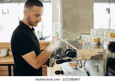 Man Barista At Coffe Shop Preparing Coffee In A Coffee Machine