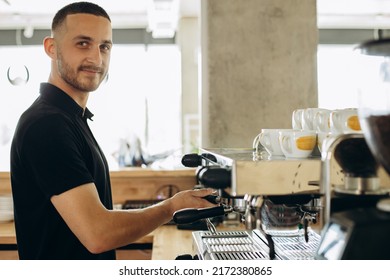 Man Barista At Coffe Shop Preparing Coffee In A Coffee Machine