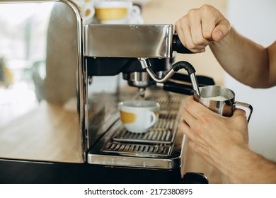 Man Barista At Coffe Shop Preparing Coffee In A Coffee Machine