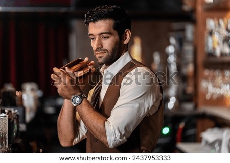Man bartender is making a drink and dancing at bar. Dance party 