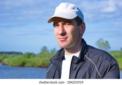 Man In A Baseball Cap On The River