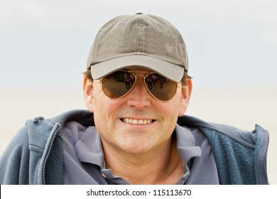 Man In Baseball Cap And Sunglasses