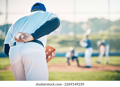 Man, baseball and pitcher ready to throw ball for game, match or victory shot on grass field at pitch. Male sports player with hand behind back with mitt in preparation for sport pitching outdoors - Powered by Shutterstock