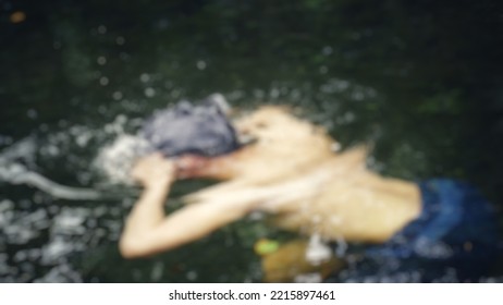 The Man Is Bathing In The Clear River Water In Blur Mode