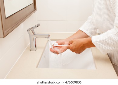 Man In Bathrobe Brush Teeth In Bathroom