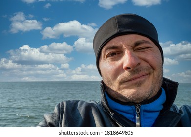 Man With A Beanie At Sea Pulling Funny Faces