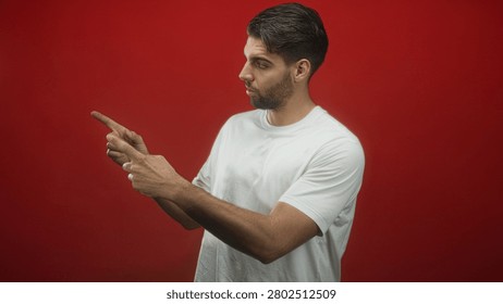 Man with beard clapping hands and pointing in studio with red backdrop; introspection reflection contemplation.