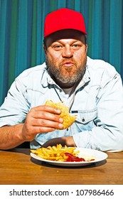 Man With Beard Eating Fast Food Meal. Enjoying French Fries And A Hamburger. Trucker With Red Cap.