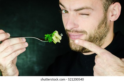 Man With A Beard Eating Italian Pasta