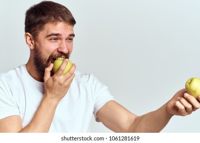 man with a beard eats an apple                              