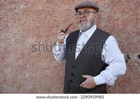 Man with beard pipe hat and vintage clothes 