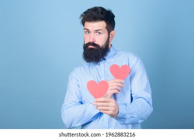 Man bearded hipster with heart valentine card. Celebrate love. Guy attractive with beard and mustache in romantic mood. Feeling love. Dating and relations concept. Happy in love. Falling in love - Shutterstock ID 1962883216