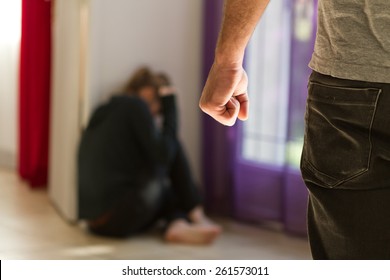 Man beating up his wife illustrating domestic violence - Shutterstock ID 261573011