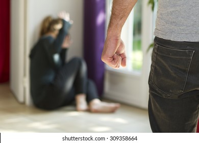 Man beating up his wife illustrating domestic violence - Shutterstock ID 309358664