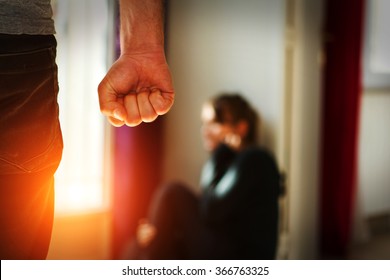 Man beating up his wife illustrating domestic violence - Shutterstock ID 366763325