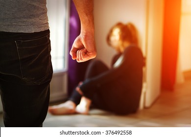 Man beating up his wife illustrating domestic violence - Shutterstock ID 376492558