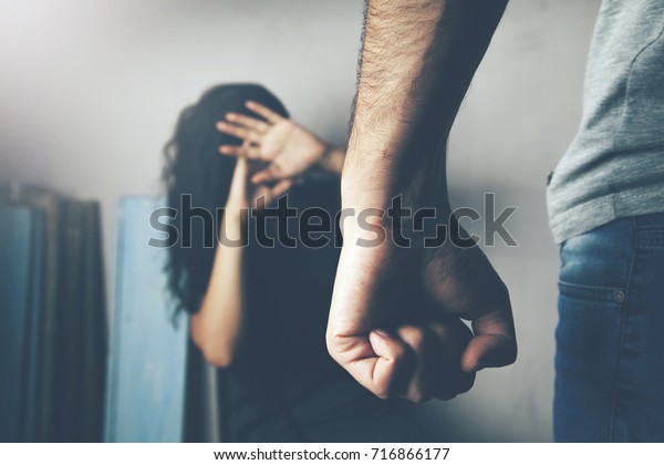 Man\
beating up his wife illustrating domestic\
violence