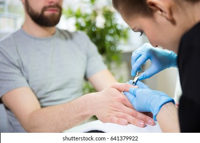 Man At Beautician's During Manicure