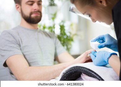 Man At Beautician's During Manicure