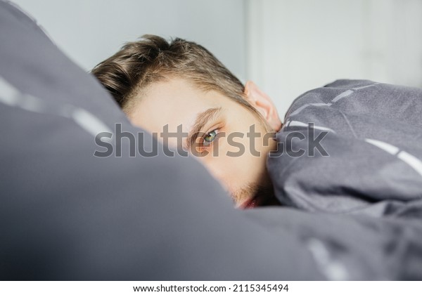 Man\
in bed, depressed and in a state of illness,\
close-up