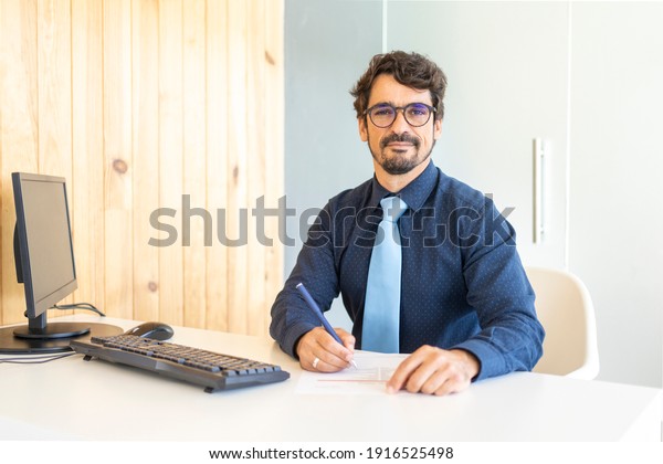 Man behind the desk, customer support service at the\
office. Bank or insurance company, paperwork, contract, documents\
or file