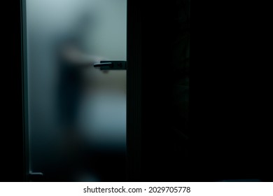 The Man Behind The Glass Door Grabs The Handle