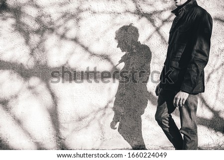 man behind the shadows of tree