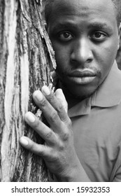 Man Behind A Tree