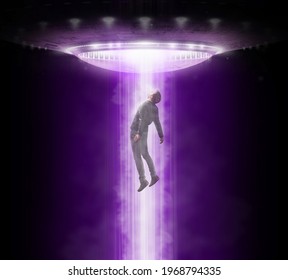 Man Being Abducted By UFO - Alien Abduction Concept