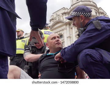 A man being arrested at the Free Tommy Robinson protest along Whitehall in London, UK, 03/08/19