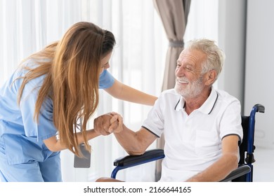 Man being cared for by a private Asian nurse at home suffering from Alzheimer's disease to closely care for elderly patients - Powered by Shutterstock