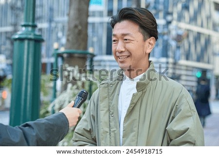 A man being interviewed on the street