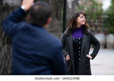 Man Being Rude, Leering And Cat Calling Or Sexually Harassing A Woman Walking On The Street.  Also Depicts Crime And Safety With A Stalker Following A Female Victim.  