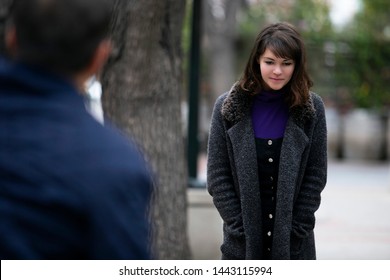 Man Being Rude, Leering And Cat Calling Or Sexually Harassing A Woman Walking On The Street.  Also Depicts Crime And Safety With A Stalker Following A Female Victim.  