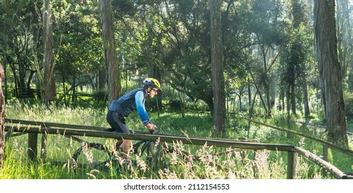 Man Between 30 And 40 Years Old Riding A Mountain Bike In The Middle Of A Forest