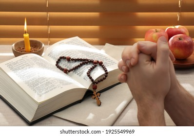 Man With Bible Praying Near Window Indoors, Closeup. Great Lent Season