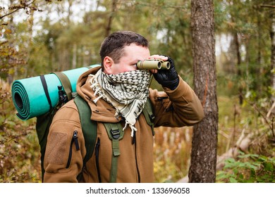 Man with binoculars at a forest. - Powered by Shutterstock