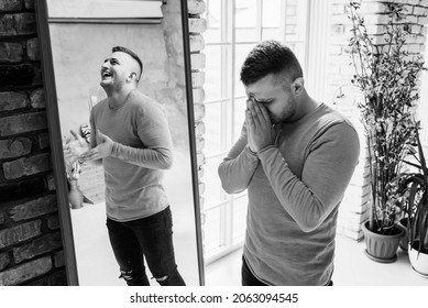 A man with bipolar disorder at the mirror. Bipolar affective disorder. A person with manic-depressive psychosis. Mental illness. A person with depression. A man is reflected in the mirror