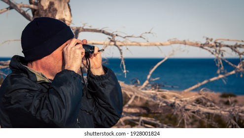 Man Birdwatching In The Winter