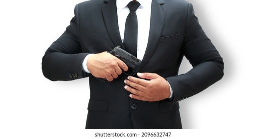 A Man In A Black Bodyguard Suit Is Holding A Pistol At Chest Level Ready To Keep The VIPs Safe. White Background Isolate.