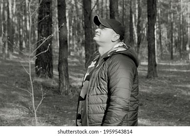 Man In A Black Cap And Jacket Walking In The Woods