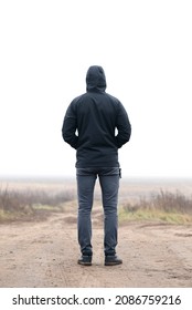 A man in black clothes stands with his back. - Shutterstock ID 2086759216