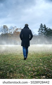 A Man In A Black Coat In Foggy Weather